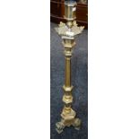 An Ecclesiastical type floor standing candlestick,