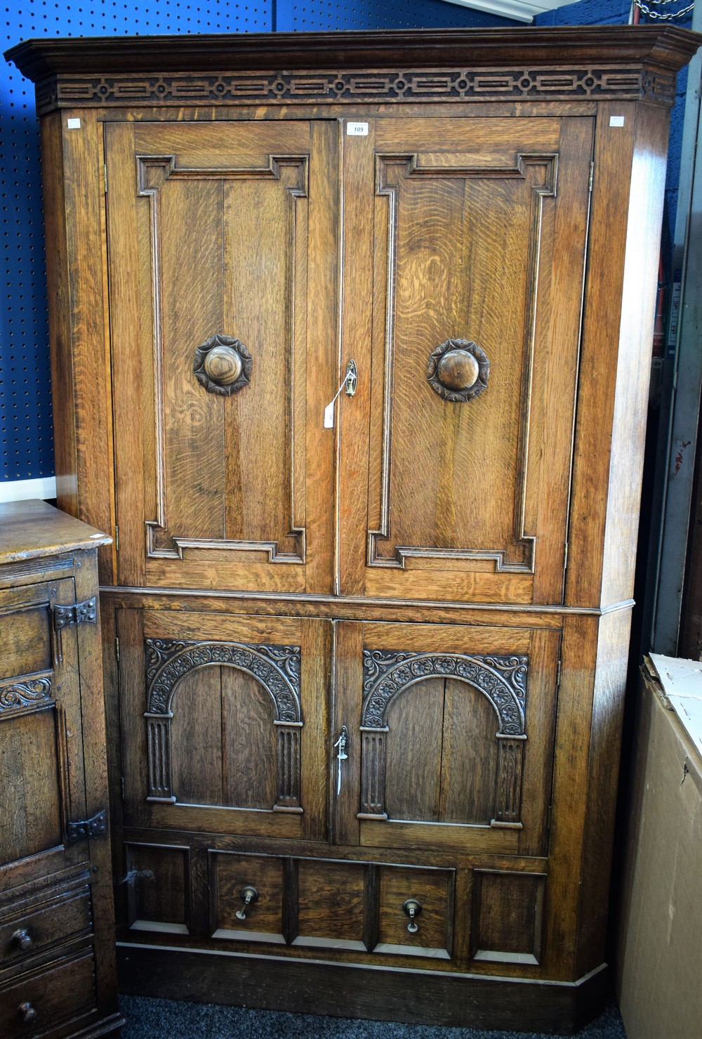 A substantial oak floor standing corner cupboard,