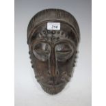 Tribal Art - a carved hardwood African mask,