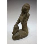 A large North American/Canadian Inuit soapstone carving, of a kneeling woman, 29cm high,