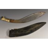 A Nepalese kukri knife, of large proportions, double-fullered blade, horn and bone grip,