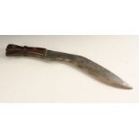 A Nepalese kukri, 29cm curved blade, two-piece hardwood grip,