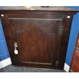 A George III oak corner cupboard, of broad proportions,