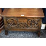 An oak blanket chest, of small proportions and carved with portrait roundels,