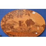 An oval marquetry panel depicting a waterside castle,