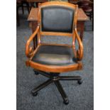 A Regency inspired swivel desk chair, scroll arms,