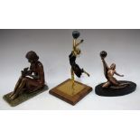 An Art Deco style painted brass and stone figure, as a dancing girl with stone globe held aloft,