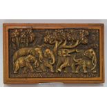 A composition desk weight, in relief with a group of elephants, 15.