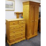 A modern pine bedroom suite comprising single wardrobe, double bed head,