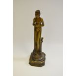 An Art Deco spelter match striker, as a scantily clad maiden, canted rectangular base,