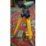 A Cooke S33 dumpy level with tripod and measuring staff.