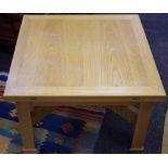 A modern pine metamorphic coffee/dining table 72cm square top converting to a dining table opening