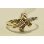A 9ct yellow & white gold, channel set diamond cross over ring, 0.25ct, size Q, 2.
