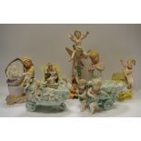 A German figural candlesticks, of a child being carried by a maiden, c.