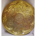A Persian brass circular tray, engraved and chased with animals and figures.