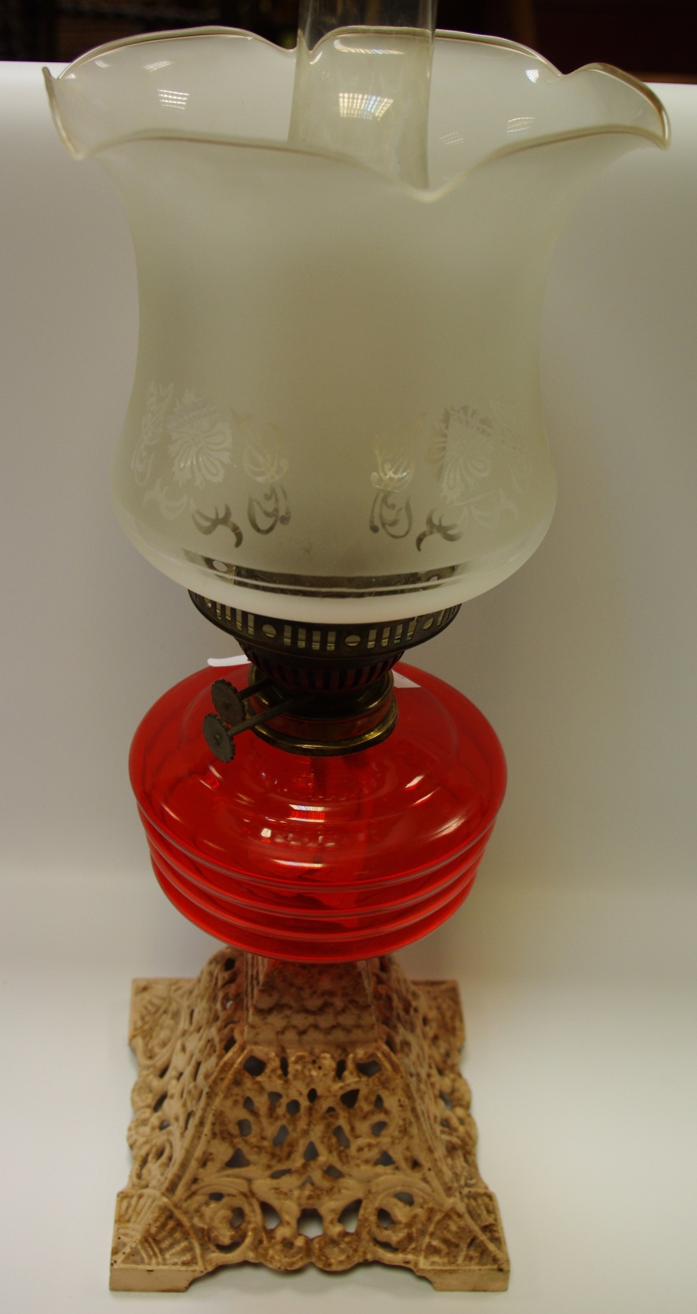 A Victorian oil lamp with cast iron base