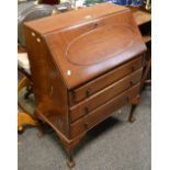 A 1940's mahogany bureau, fall front over three drawers, cabriole legs,