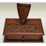 An early 20th century carved oak pocket watch stand