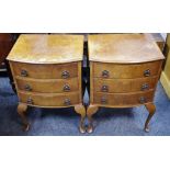 A pair of reproduction walnut veneered bow front bedside chests, three drawers, cabriole legs,