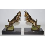 A pair of Art Deco models of leaping deer, marble bases, c.