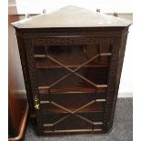 A Chippendale revival wall mounted corner cabinet, dentil cornice, canted angles,