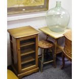 A glass carboy; a bamboo occasional table;