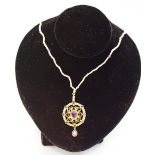 A 9ct gold filigree pendant set with an oval central amethyst,