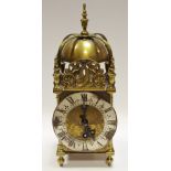 An Elliott lantern clock with Roman numerals and silvered chapter ring,