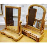 A Victorian mahogany dressing mirror, arched plate, drawers to base; another,