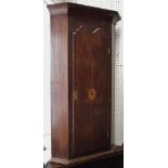 A oak wall mounted corner cabinet of small proportions, outswept cornice, canted angles,