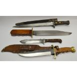 A WWII bayonet; a Solinger Bowie knife; a German knife;