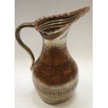 A 19th Century Persian tinned copper pitcher decorated with deer & birds amidst scrolling foliate