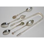 A pair of George III silver bright cut sugar tongs; Irish silver teaspoon;