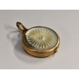 A 19th century gilt metal and mother of pearl vinaigrette, hinged cover enclosing a pierced grille,