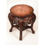 A Chinese hardwood jardiniere stand, circular top with inset soapstone panel,