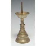 A 16th century brass pricket candlestick, dished wax pan,