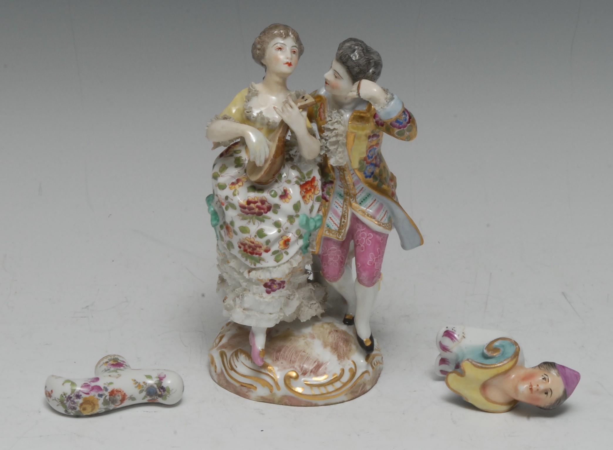 A late 19th century German porcelain figure group, of a courting couple in 18th century dress,