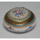 A 19th century Palais-Royal enamel circular bonbonnière, hinged cover enclosing a gilt interior,