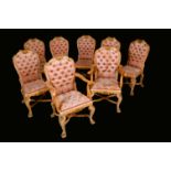 A set of eight Baroque Revival parcel-gilt dining chairs, shaped arched backs,