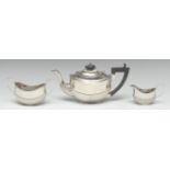 An Edwardian silver three piece half-fluted oval bachelor's tea service, comprising teapot,