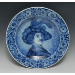 A Delft circular charger, painted in underglaze blue, after Rembrant van Rijn, self portrait, 42.