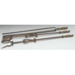 A set of three Baroque steel and brass fire irons, comprising tongs, shovel and poker,