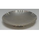 A George V silver shaped circular footed dish, shaped rim, raised footring, 20.