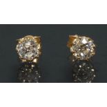 A pair of diamond solitaire stud earrings, each round old brilliant cut diamond approx 0.