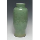 A Chinese celadon ovoid vase, incised in relief with stylised flowers and foliage, 36cm high,