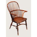 A 19th century yew and elm Windsor elbow chair, hooped back with curved arm rail, saddle seat,