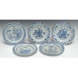 A pair of Chinese circular plates, decorated with vases, low tables, foliage and precious objects,