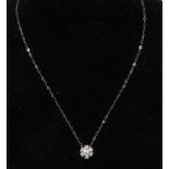 A diamond floral cluster pendant necklace,