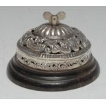 An Edwardian silver desk bell, pierced and embossed with flowers and scrolling leaves,