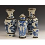 A pair of Chinese Crackle Glaze ovoid vases, painted in underglaze blue with figures,